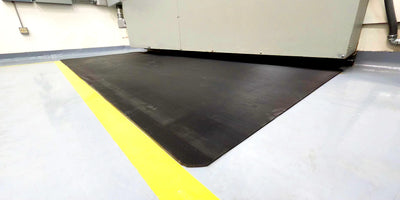 Dielectric switchboard mat under electrical cabinet